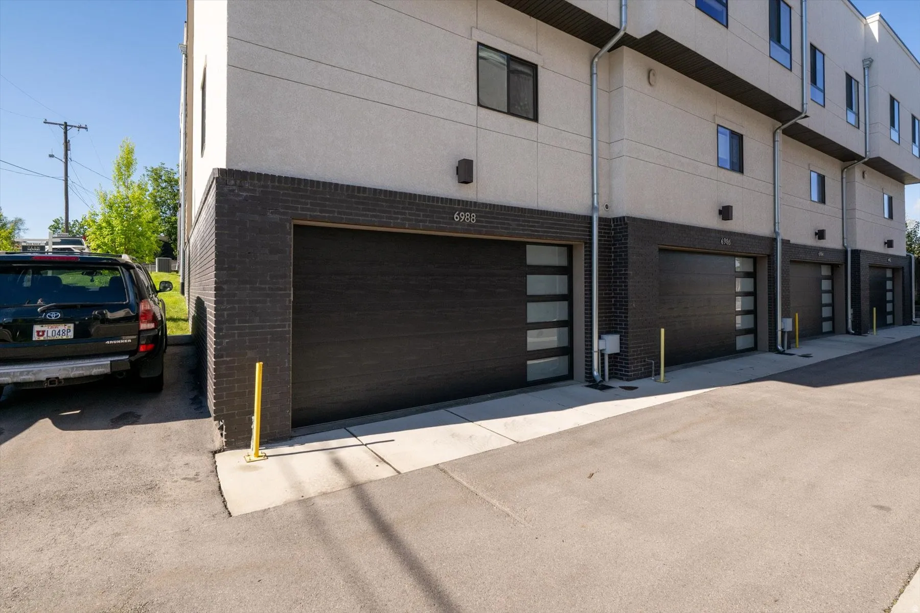 Modern exterior featuring a dark brick facade and light stucco siding