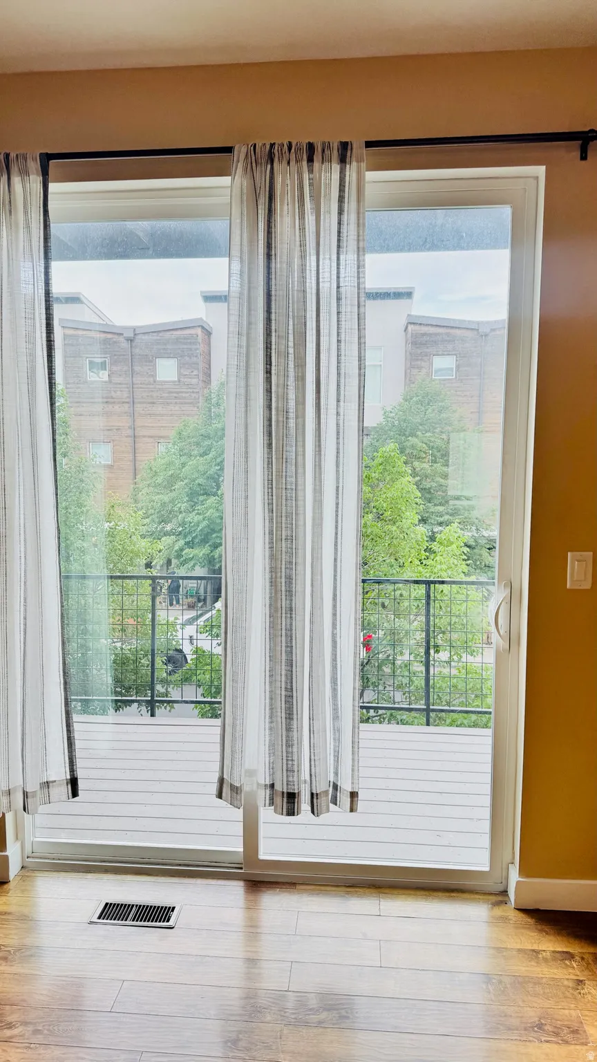 Sliding glass doors opening to a private deck with dark metal railings