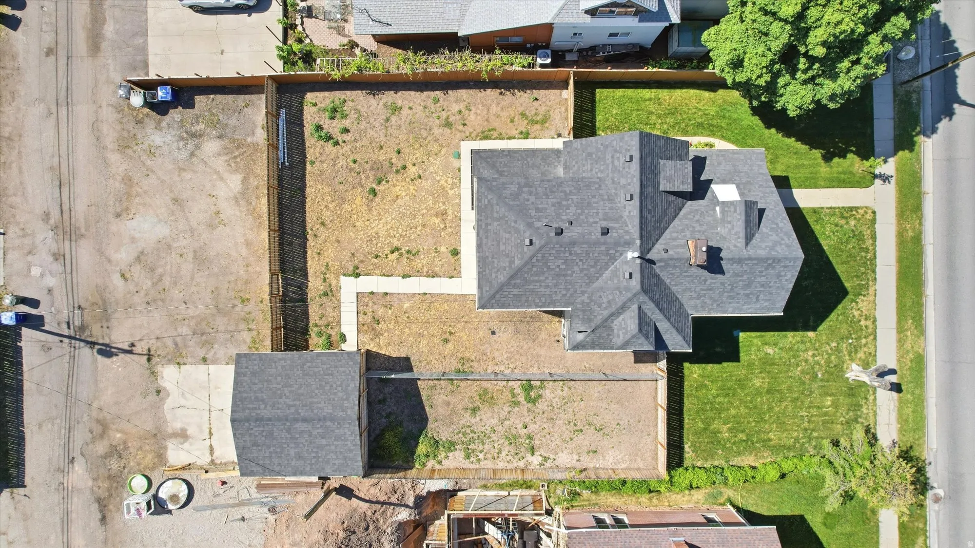 Aerial view showcasing a residential property with a detached auxiliary structure
