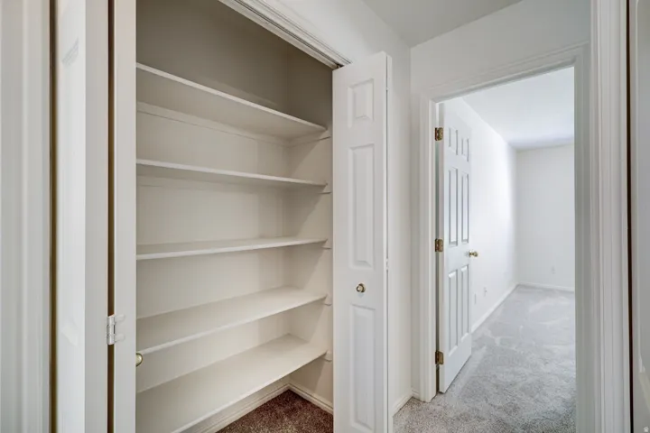 Built-in shelving unit with multiple white shelves