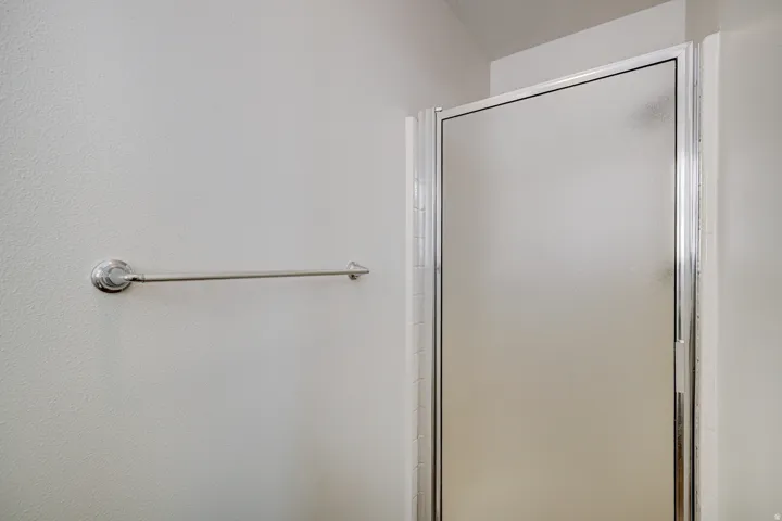 Primary Bathroom with Frosted glass shower enclosure with polished chrome framing and a coordinating towel bar