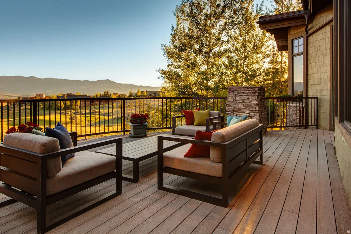 Spacious outdoor deck with composite decking and black metal railings