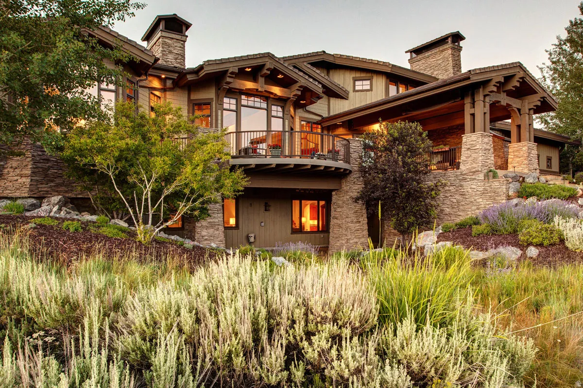 Craftsman-style residence featuring extensive stone accents and wood siding