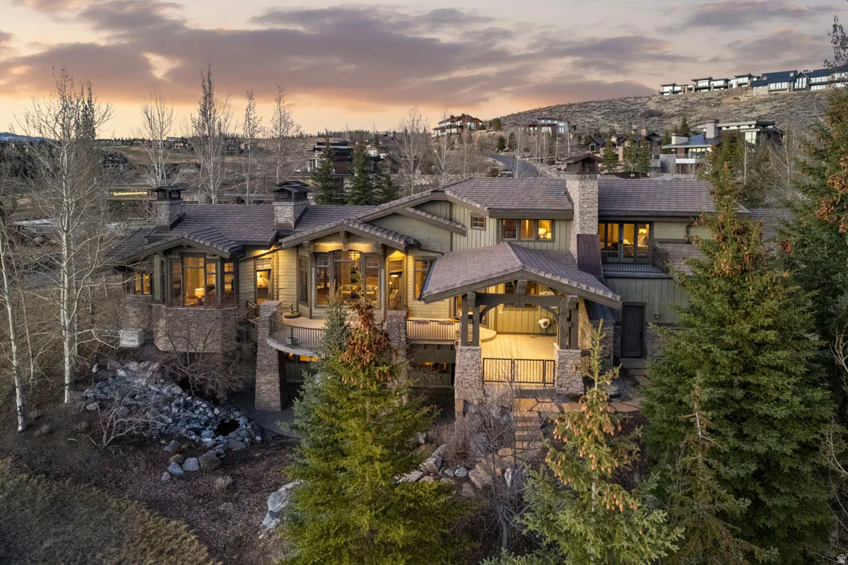 Multi-level mountain modern residence featuring extensive stone accents and wood siding