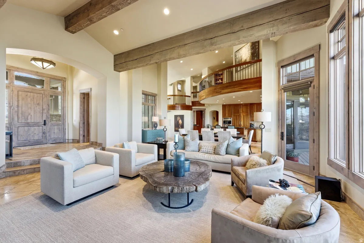 Spacious main living area featuring exposed wood beams and recessed lighting