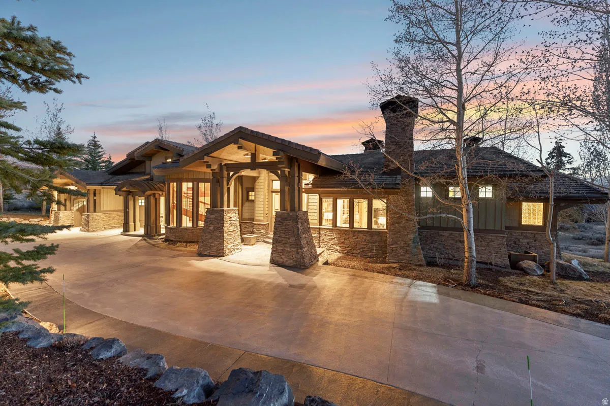 Craftsman-style residence featuring a stone and wood exterior