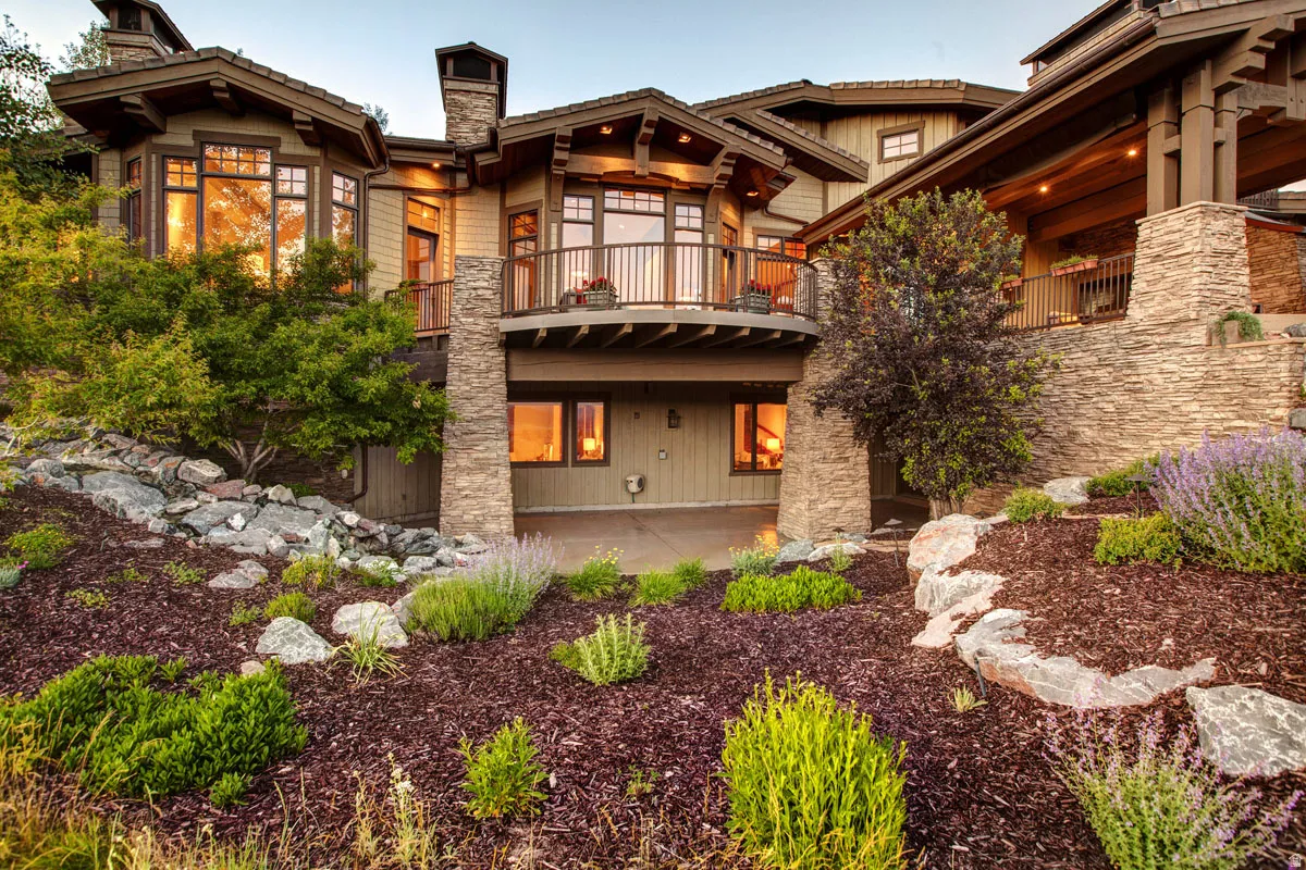 Multi-level architecture featuring natural wood siding and extensive stone accents