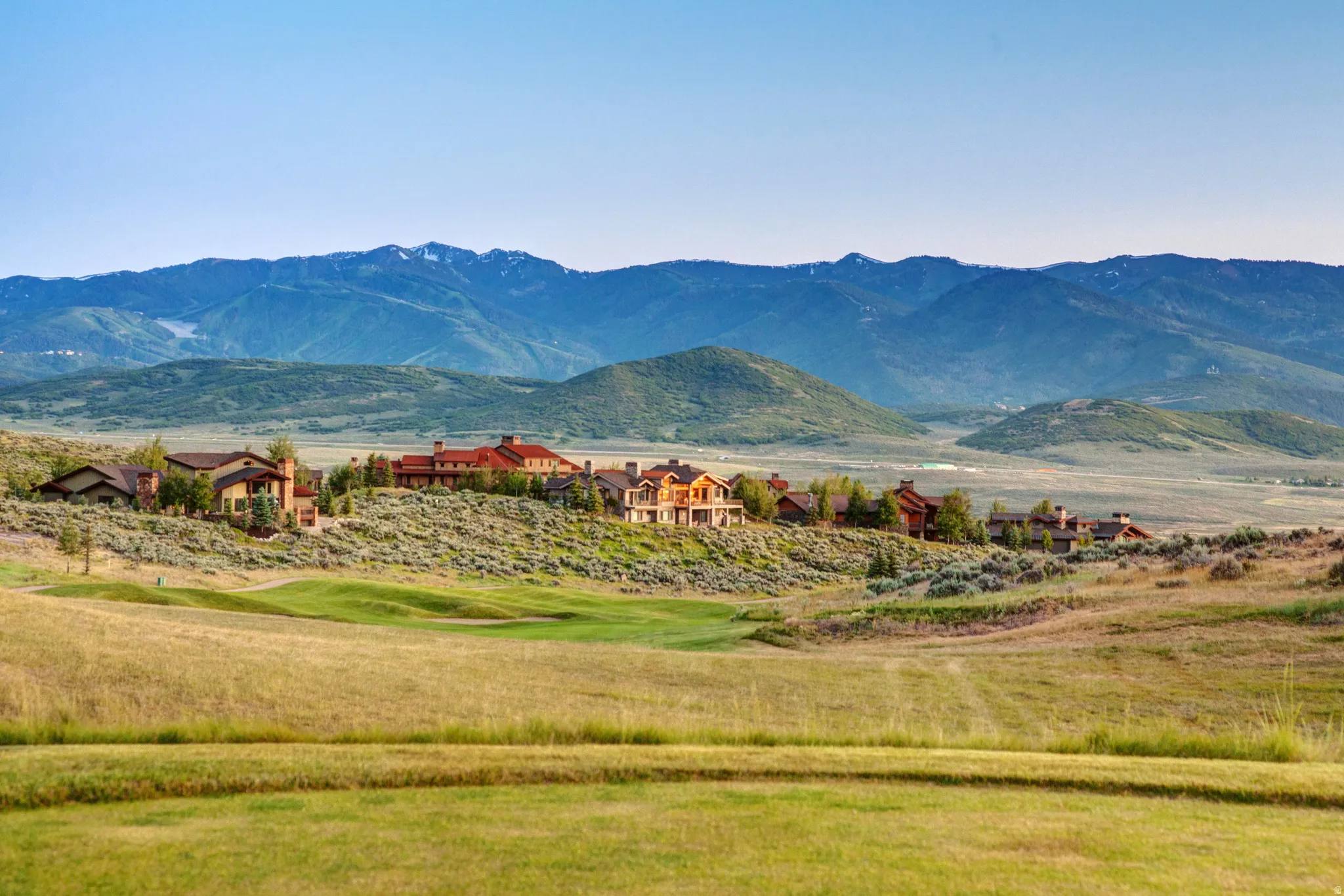 Expansive mountain scenery framing a collection of residences