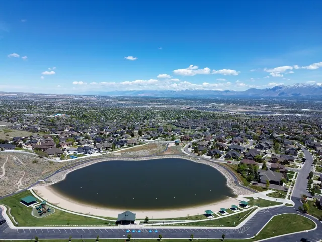 Expansive aerial showcasing a large residential area with a prominent central lake feature