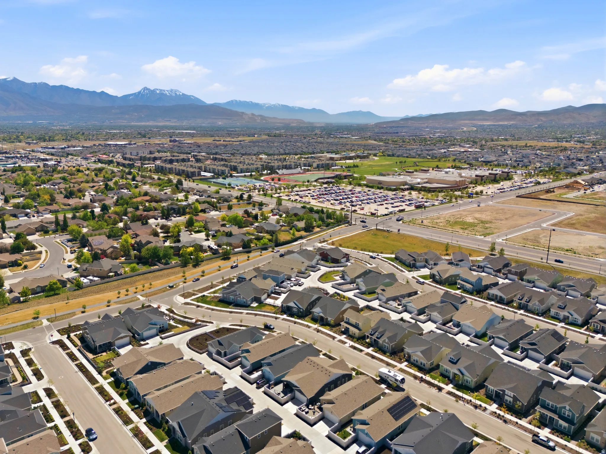 New construction homes featuring modern architecture, asphalt shingle roofs, and attached garages