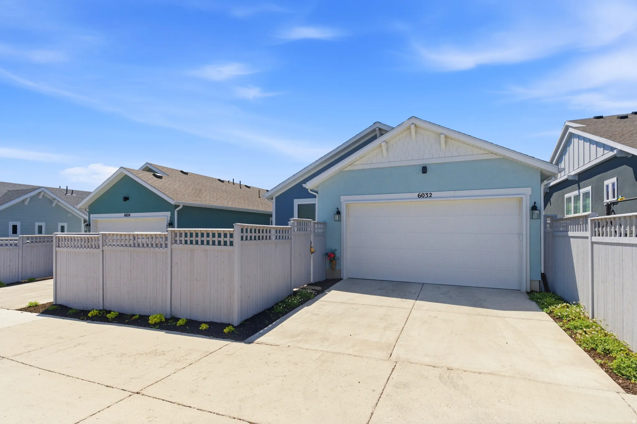 Light blue exterior featuring white trim and a white garage door
