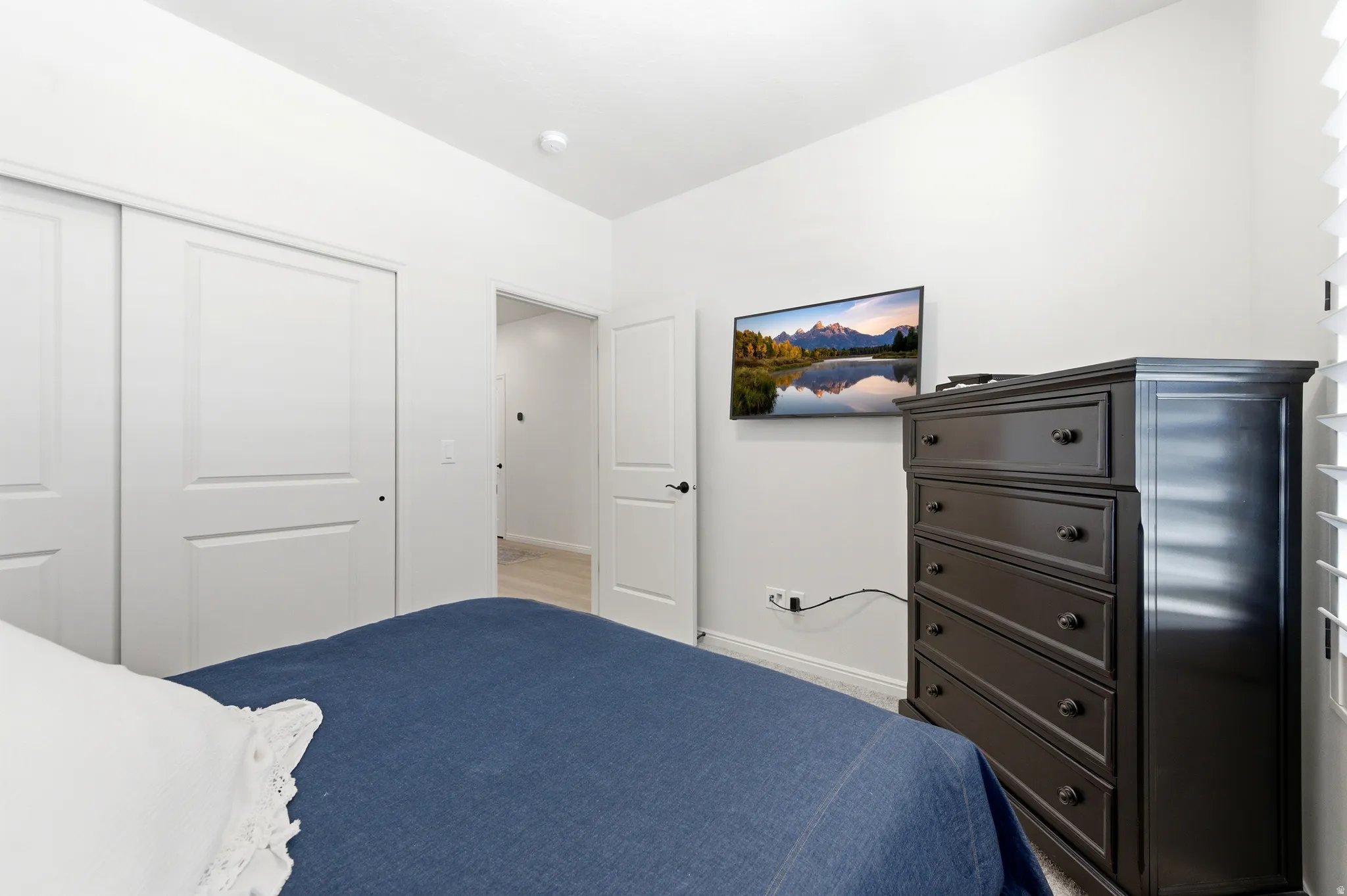 Bedroom featuring light wood-finish flooring, white walls, and a recessed ceiling light