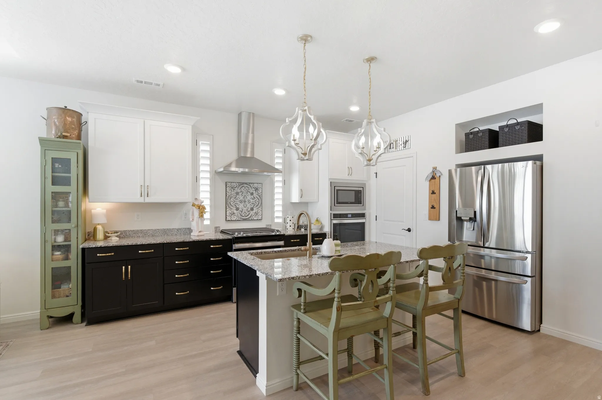 Modern kitchen featuring light wood-finish flooring and recessed lighting