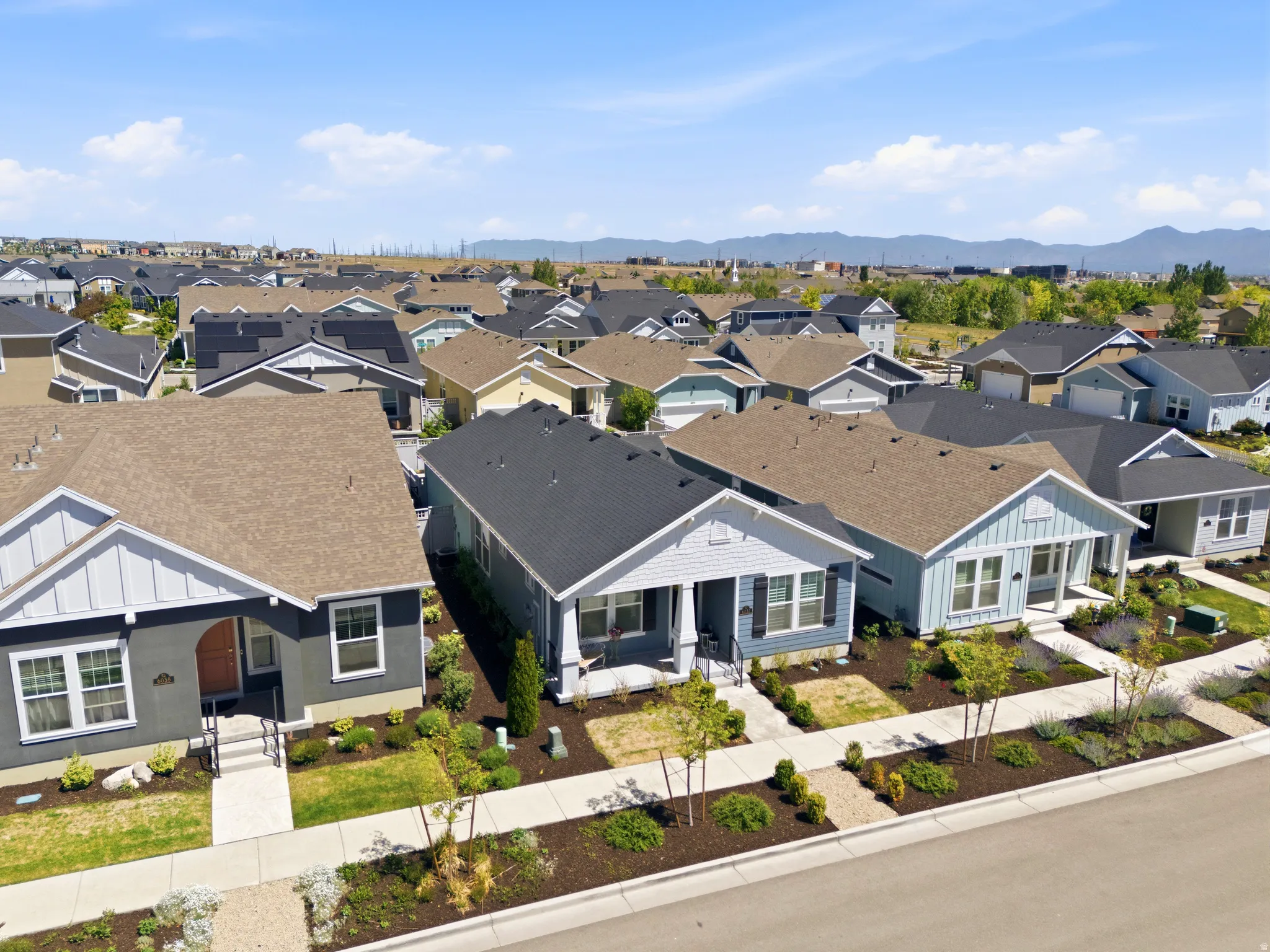 Aerial perspective showcasing a developed residential neighborhood with a variety of single-story homes