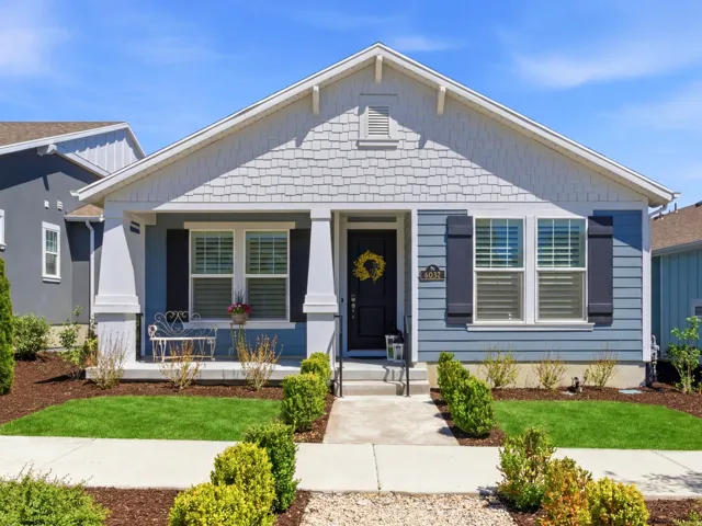 Blue siding exterior with white trim and grey shake accents