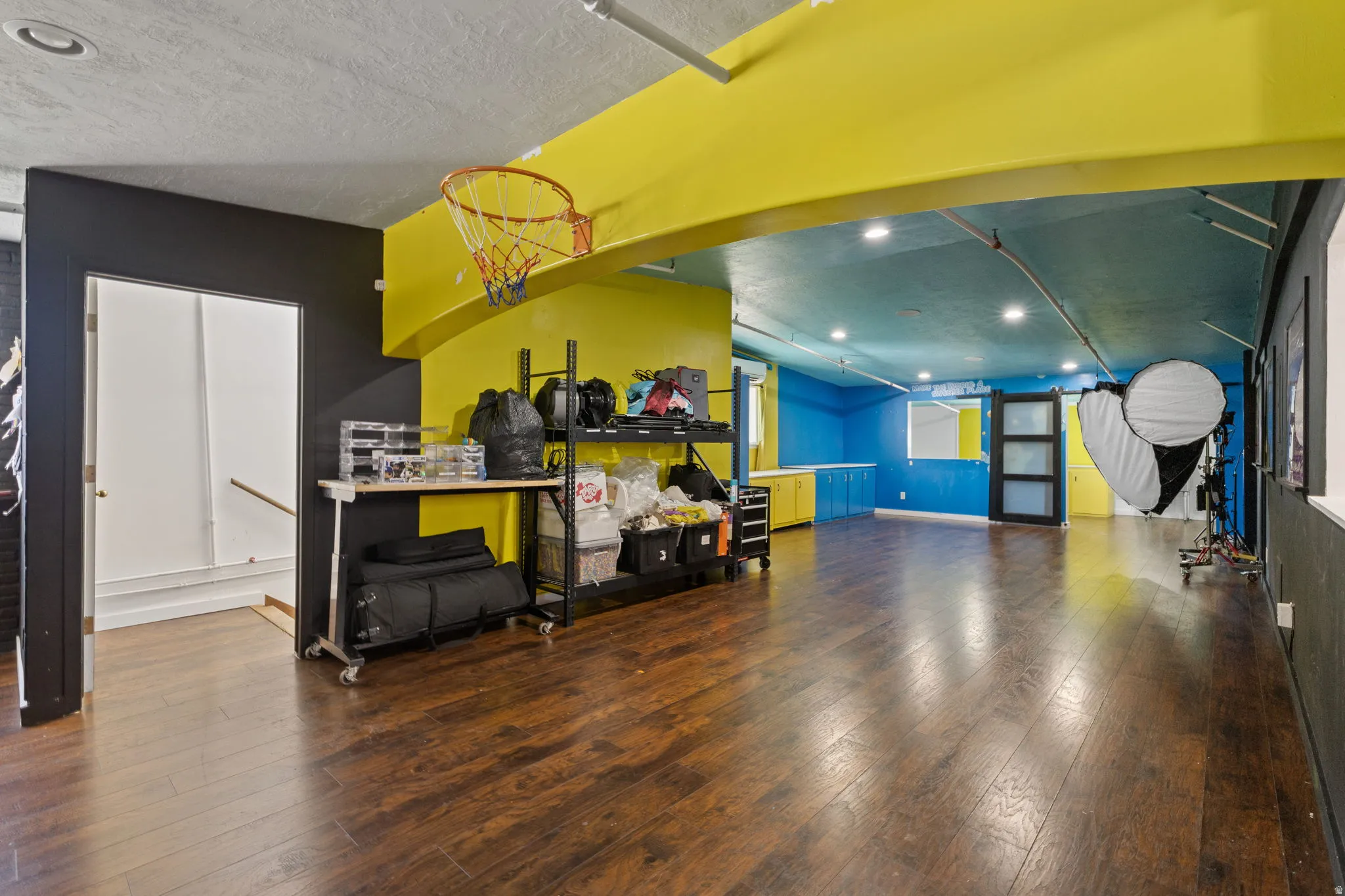 Spacious lower level featuring wood-finish flooring, recessed lighting, and a vibrant color palette