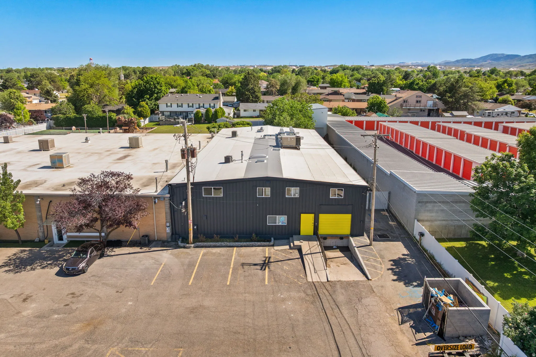 Industrial building with dark grey siding and bright yellow doors