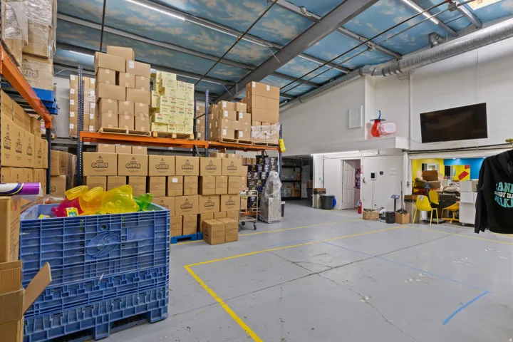 Spacious warehouse interior featuring high ceilings and exposed ductwork