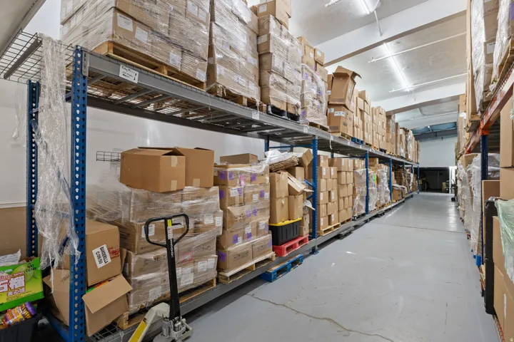 Warehouse interior featuring concrete flooring and high ceilings
