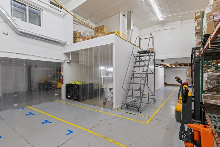 Industrial interior with high ceilings and fluorescent lighting