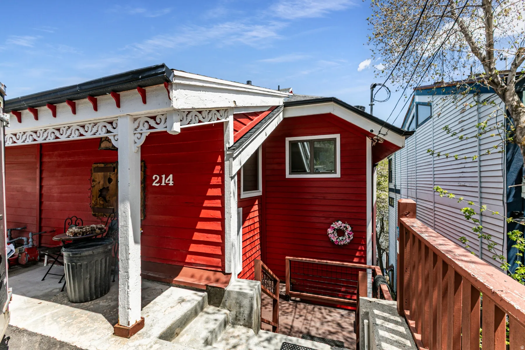 Red exterior siding with white trim accents and decorative porch corbels