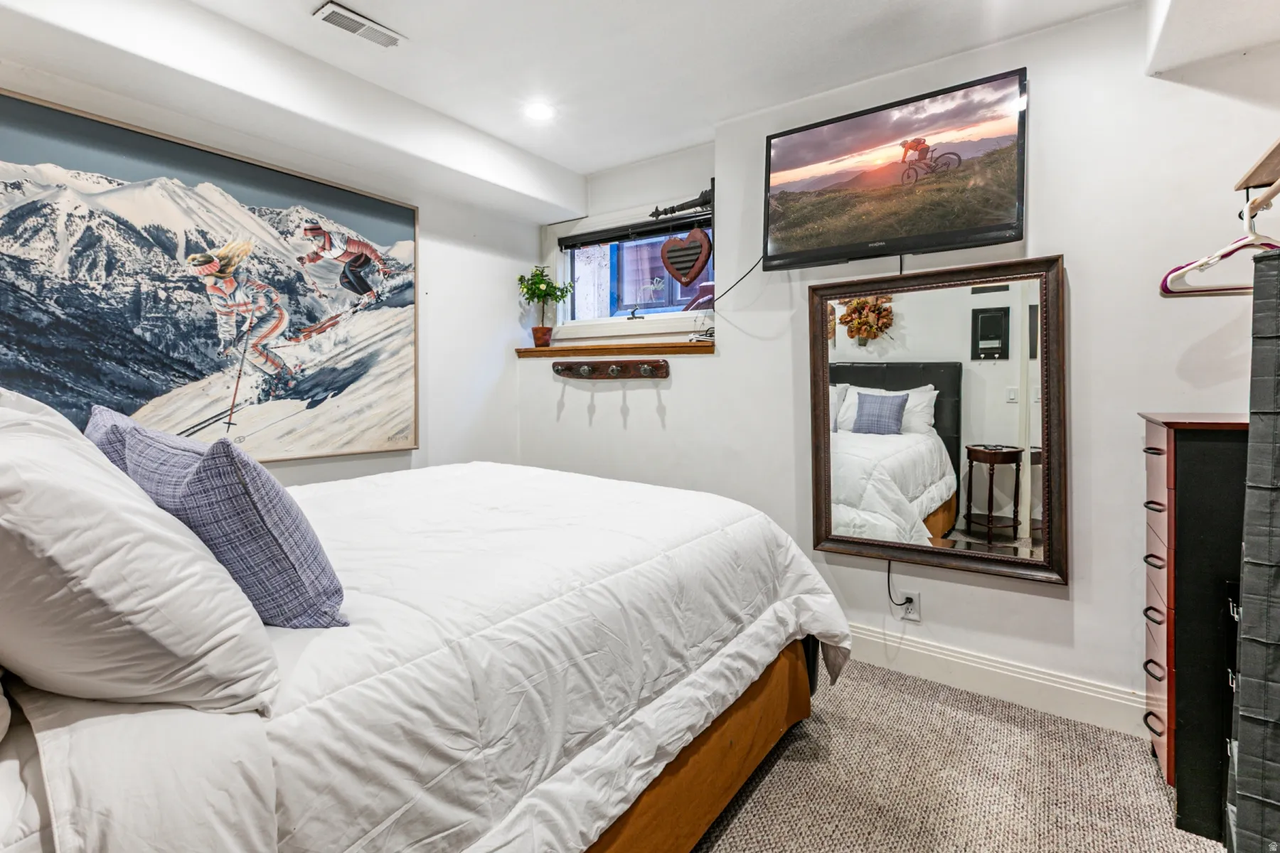 Carpeted flooring, recessed lighting, and a wall-mounted television