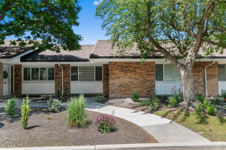 Brick exterior with white trim and a brown shingle roof