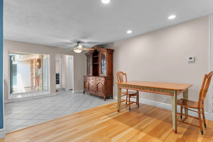 Bright interior space featuring a combination of wood-finish flooring and diagonal tile