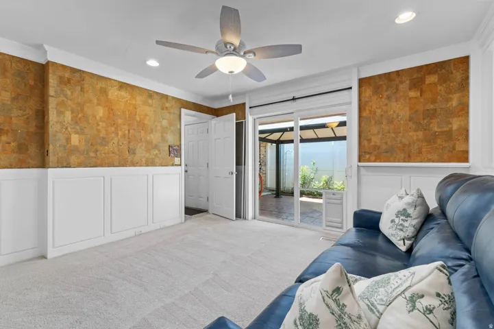Living space featuring wainscoting and textured wall covering