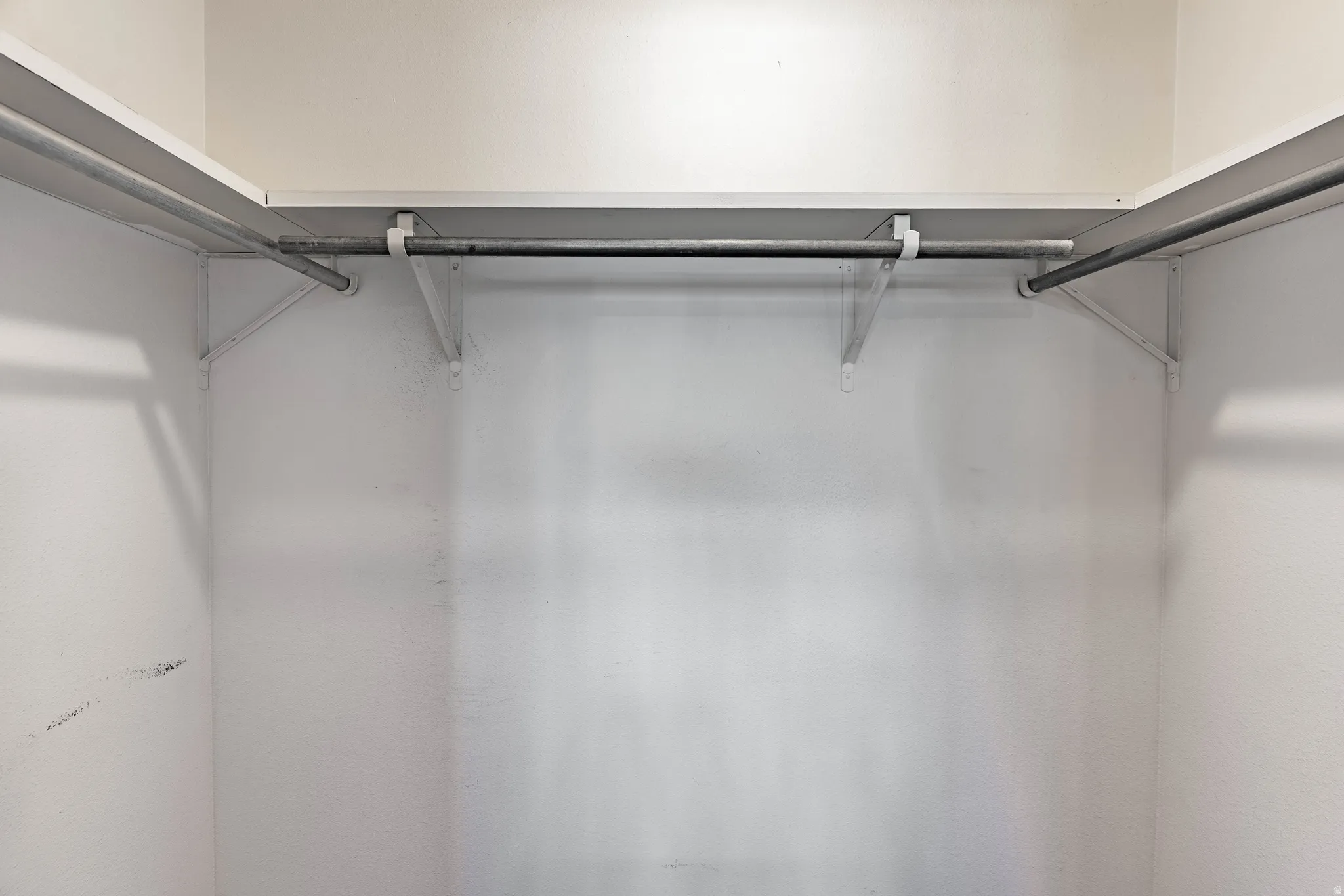White shelving system with metal hanging rods