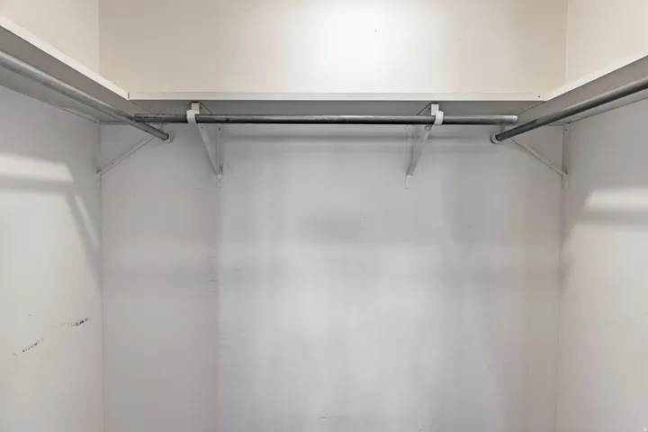 White shelving system with metal hanging rods