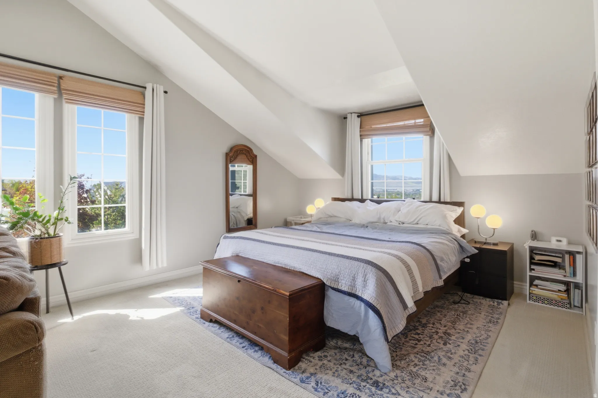 Carpeted room with sloped ceilings and light grey walls