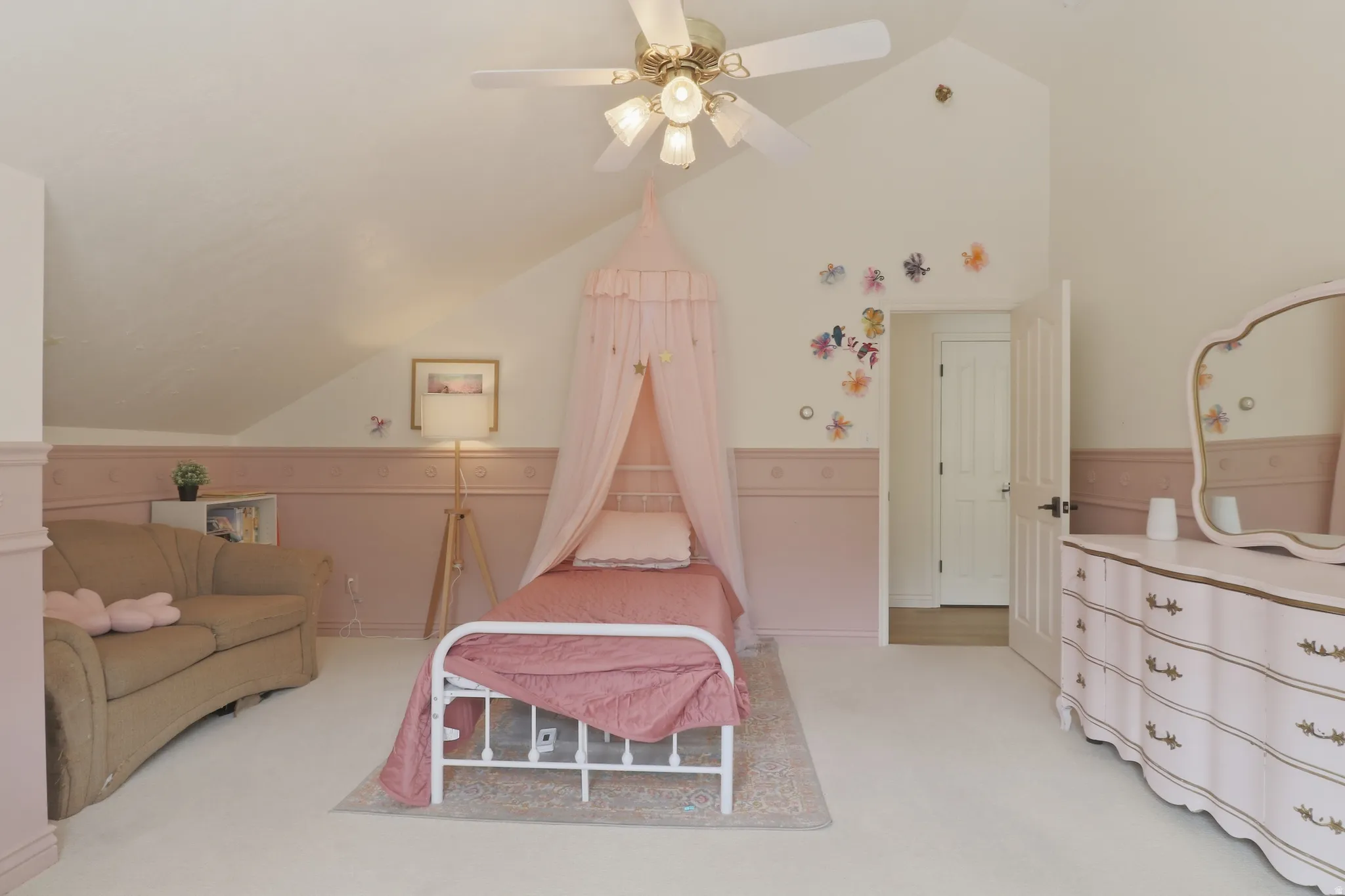 Room with vaulted ceiling, ceiling fan, and carpeted flooring