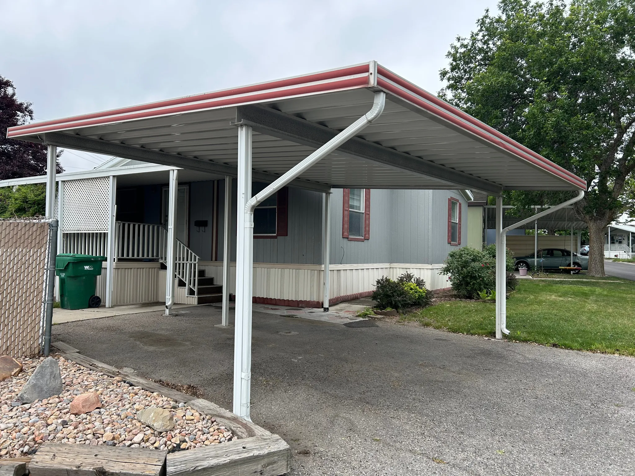Carport structure with metal roofing and white support columns