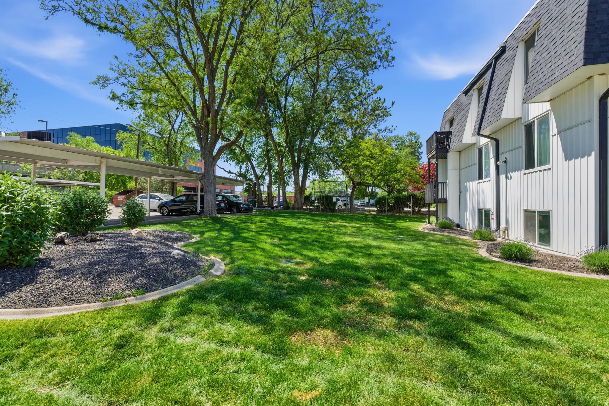 Expansive lawn area with mature trees and landscaping