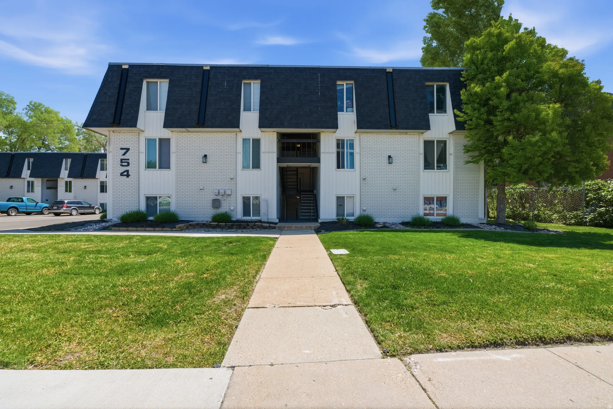 White exterior with a dark gambrel roofline