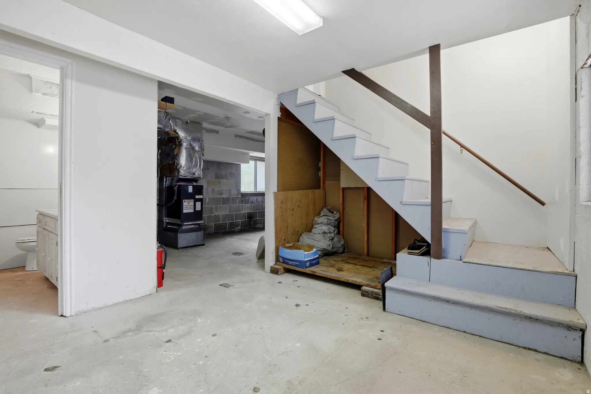 Staircase with painted treads and risers, featuring a wood handrail