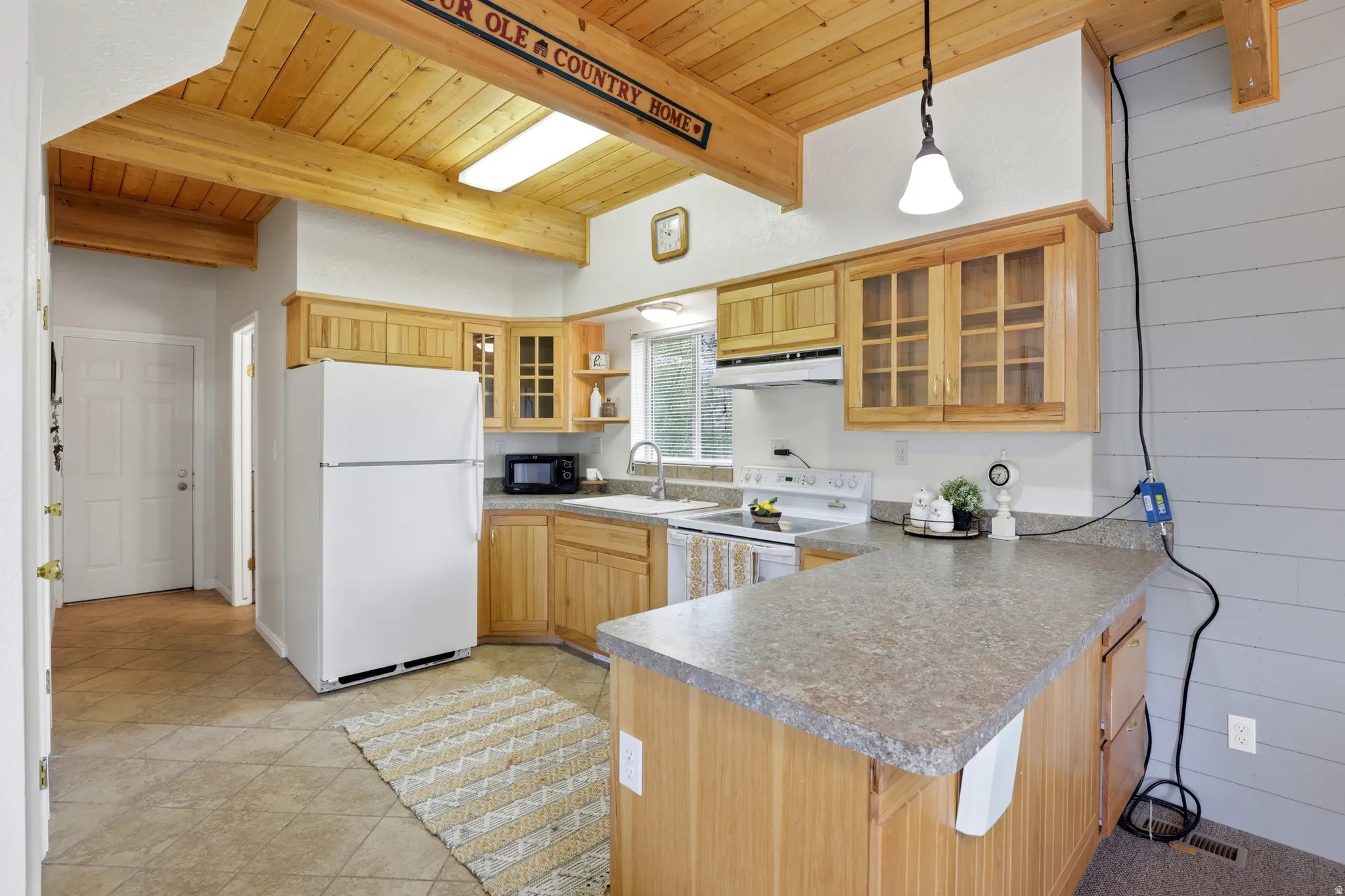 Kitchen featuring a wood-finish vaulted ceiling with exposed beams and recessed lighting