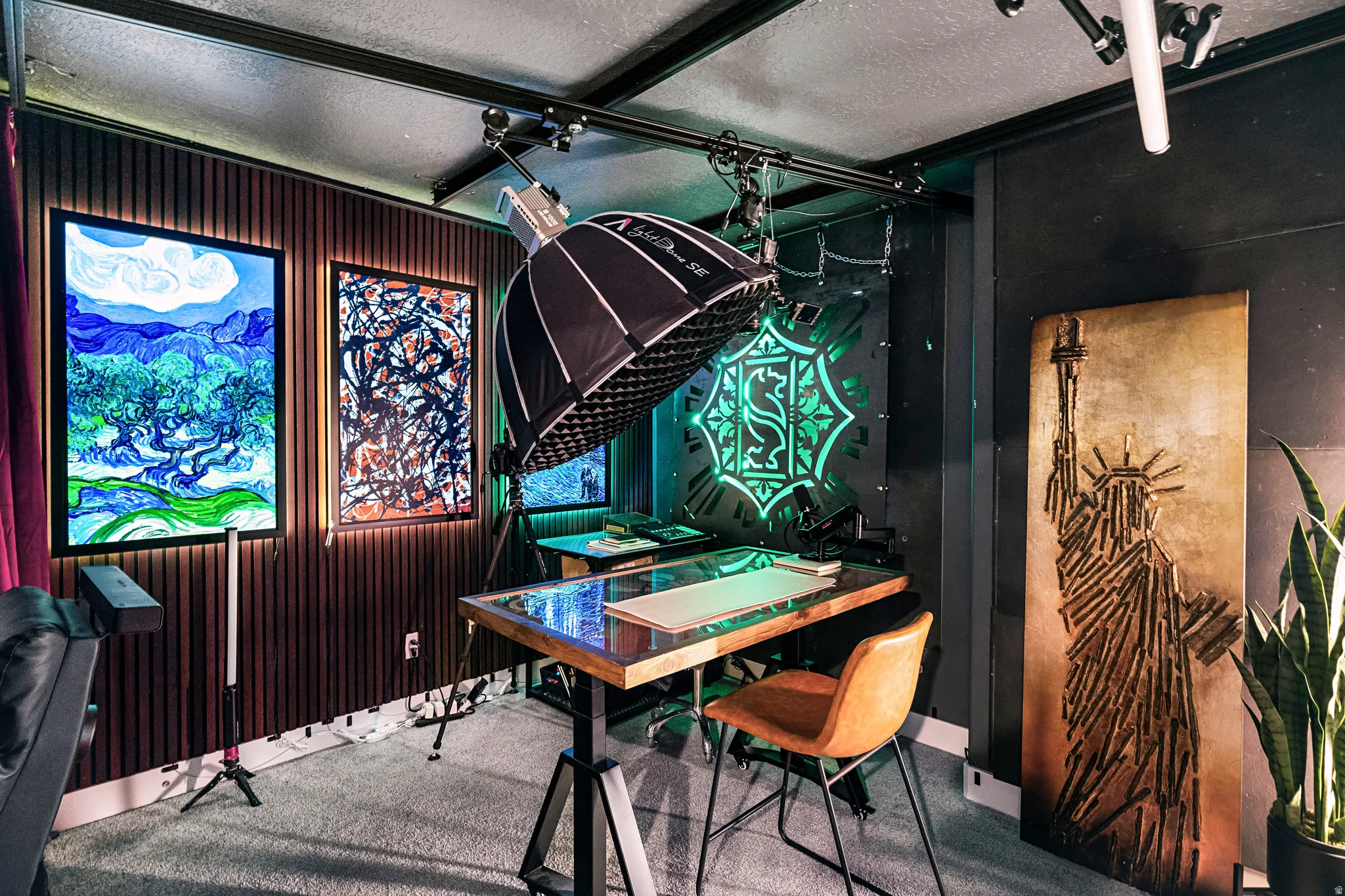 Accent wall featuring vertical wood paneling and illuminated art installations