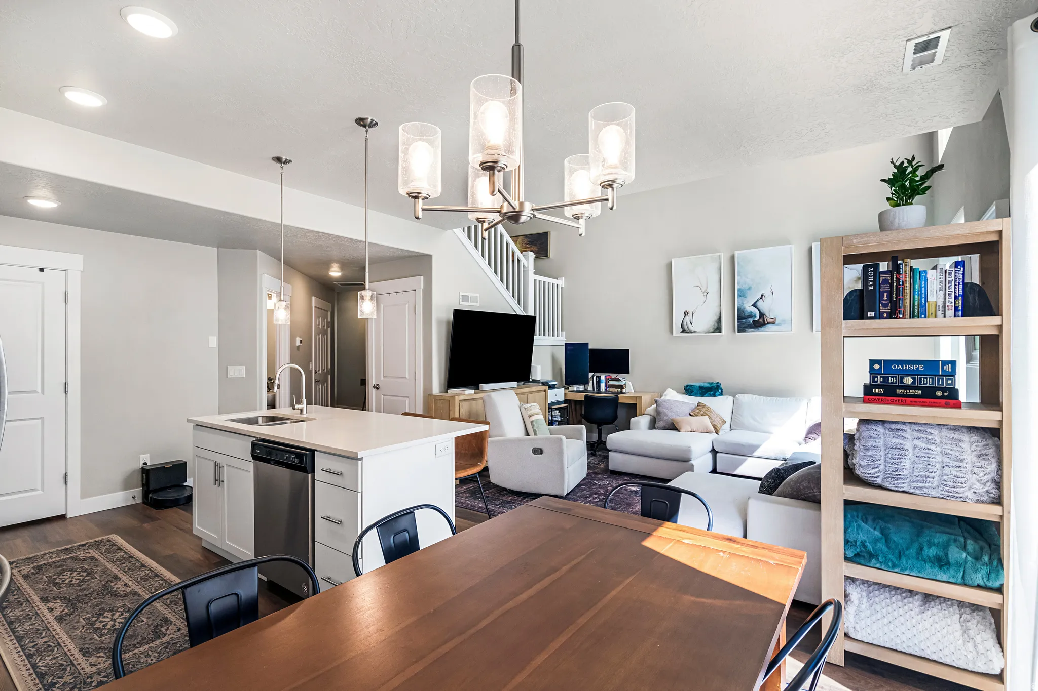 Kitchen island with a stainless steel sink and integrated dishwasher