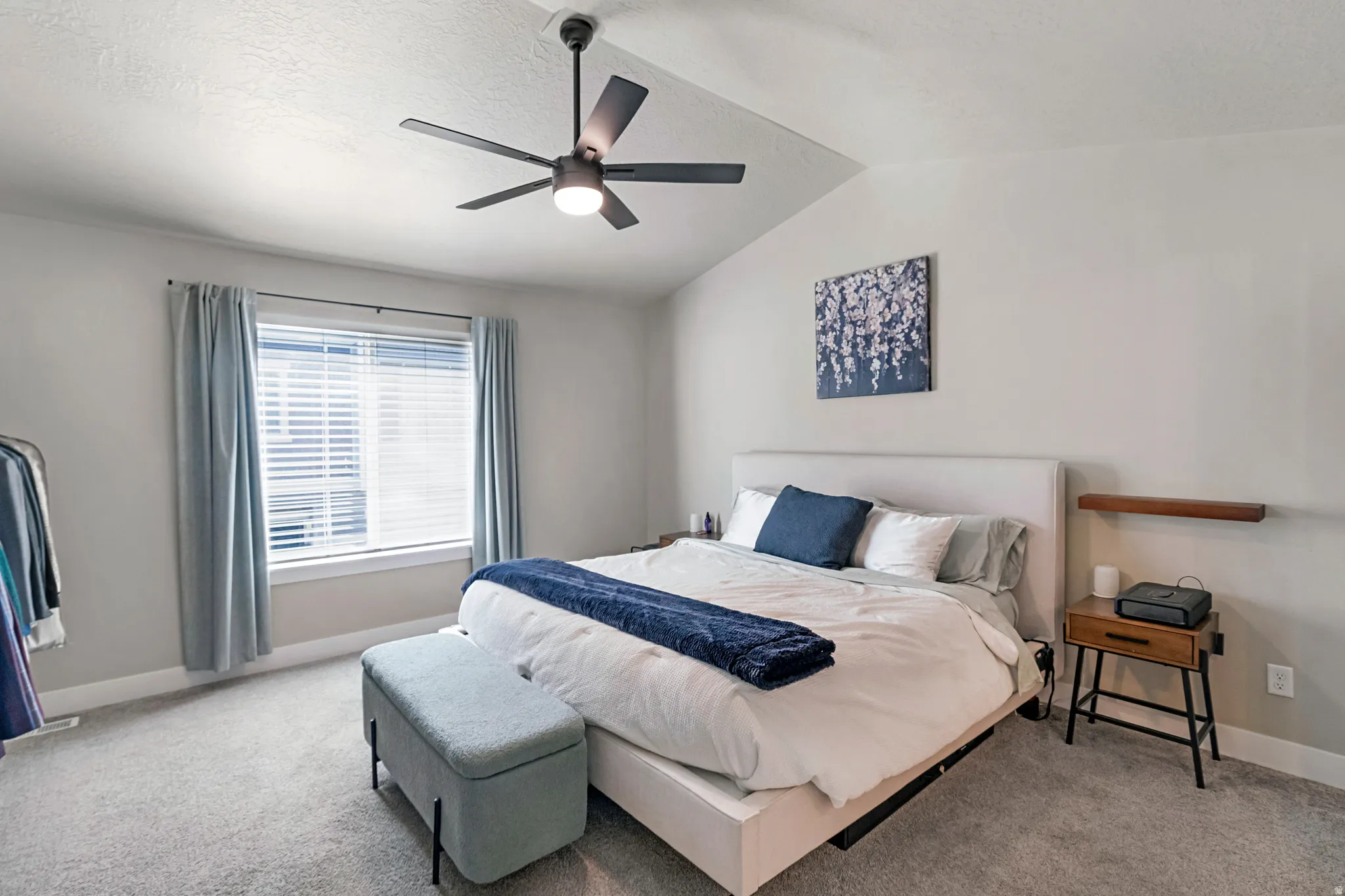Vaulted ceiling featuring a ceiling fan with integrated lighting