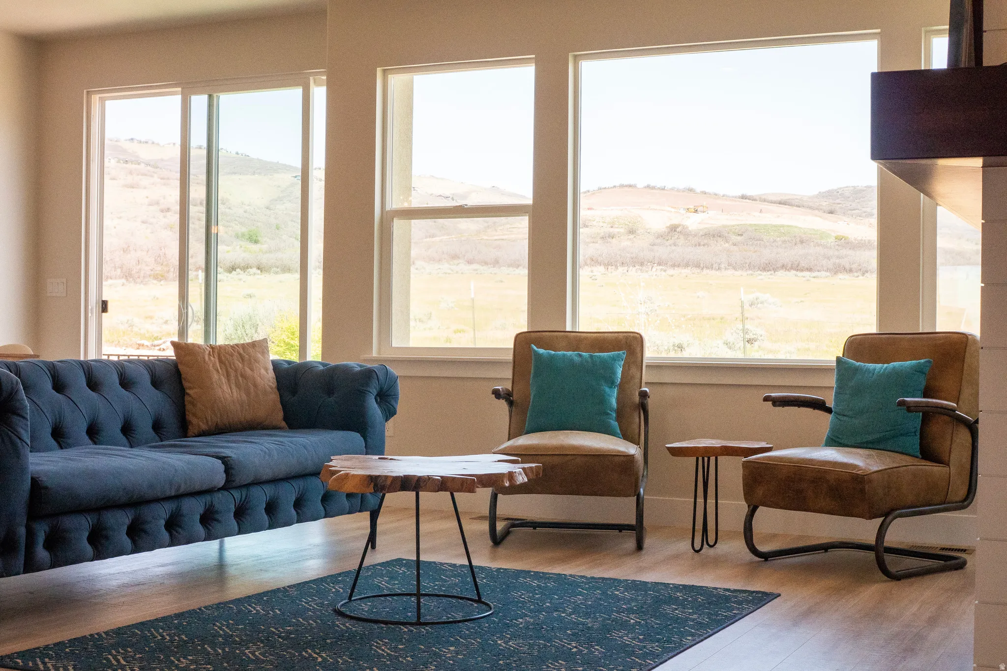Spacious room featuring multiple large windows and a sliding glass door, providing abundant natural light and expansive outdoor scenery