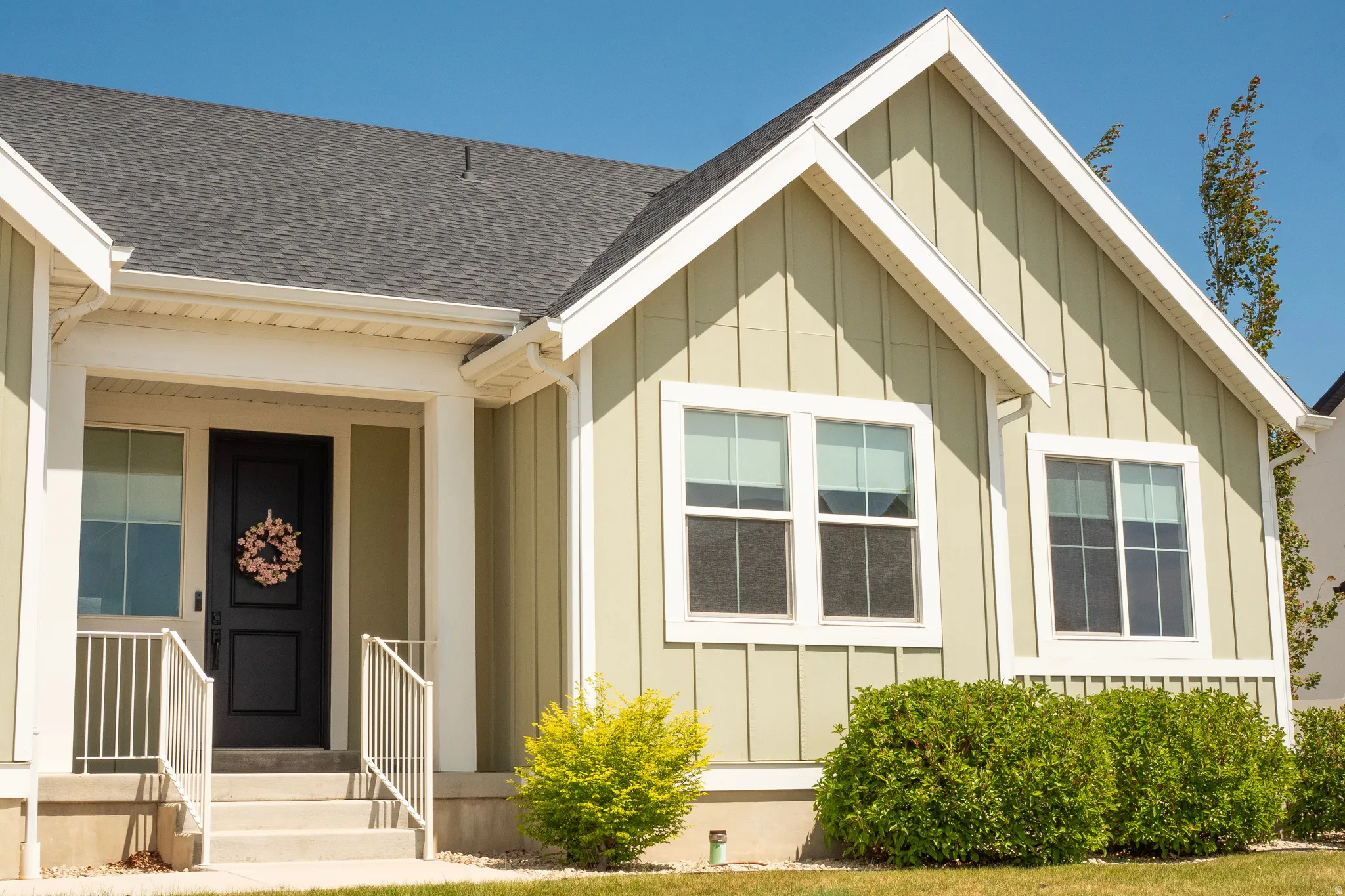 Light green exterior siding with white trim