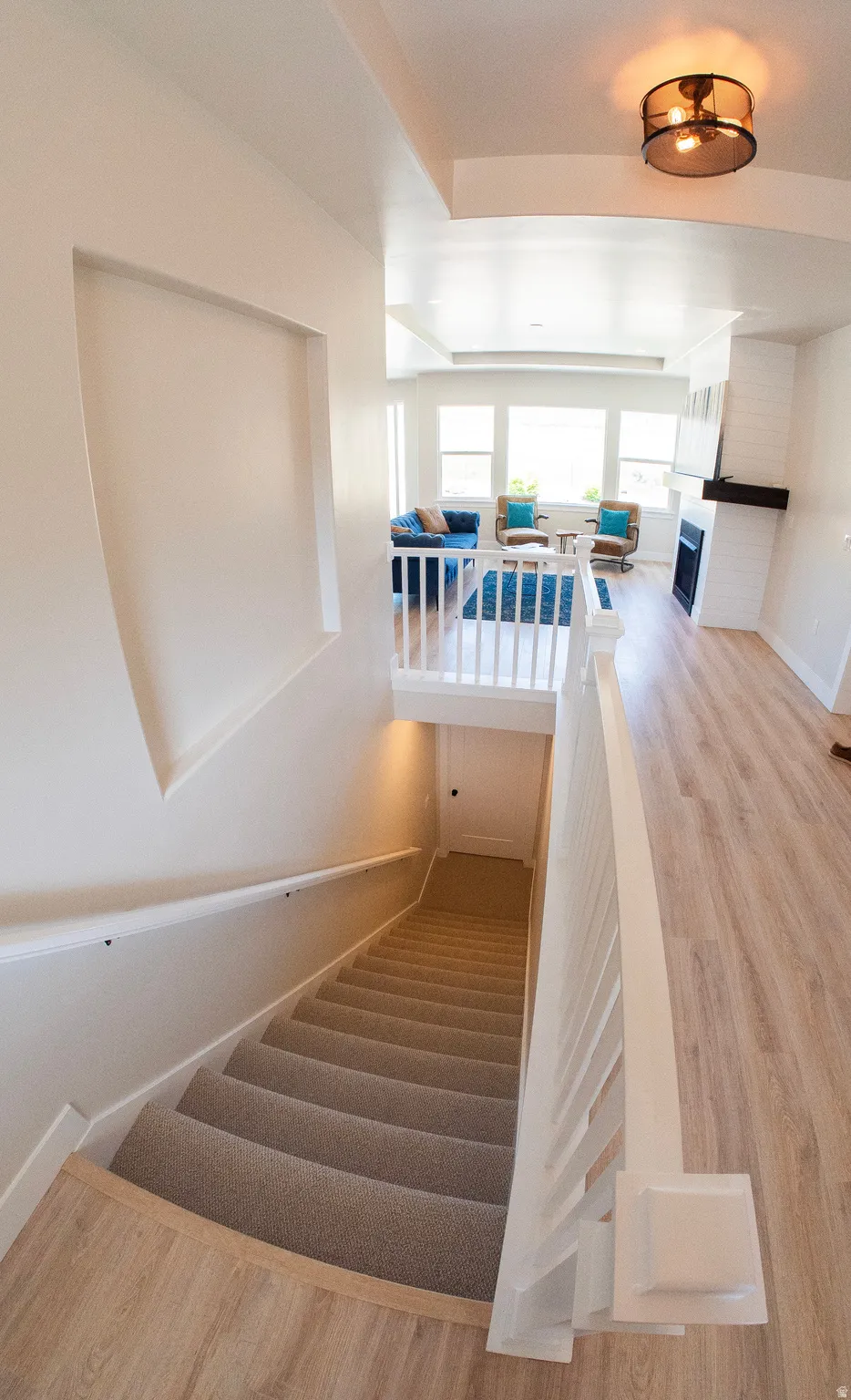 Open concept living space featuring a fireplace, large windows, and recessed lighting