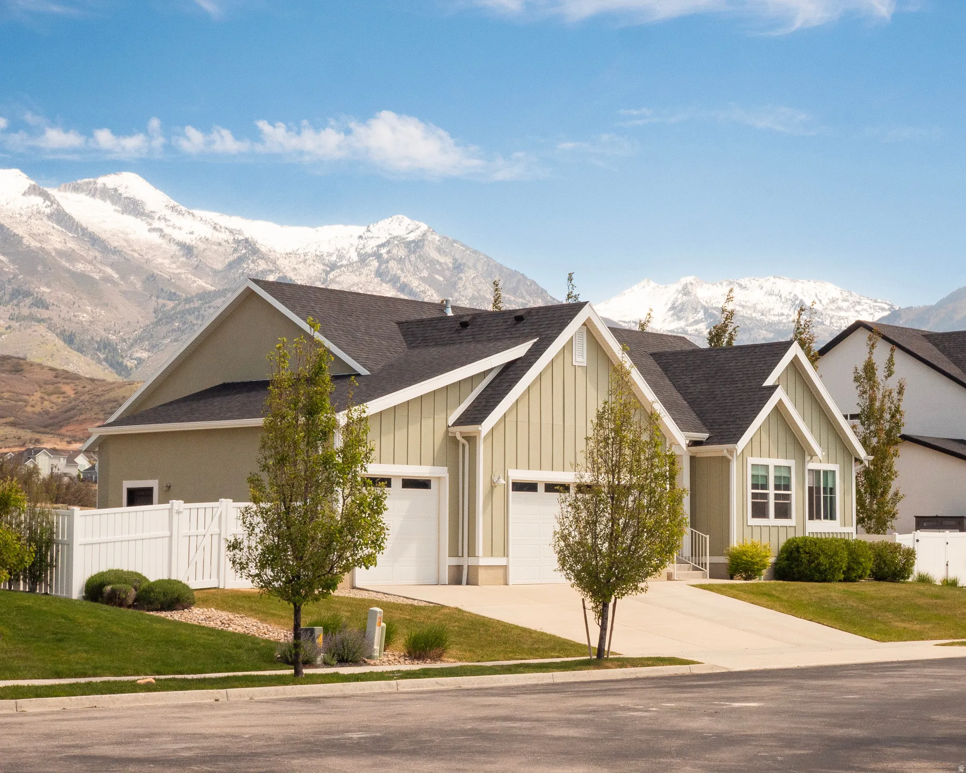 Modern residence featuring light green siding and white trim