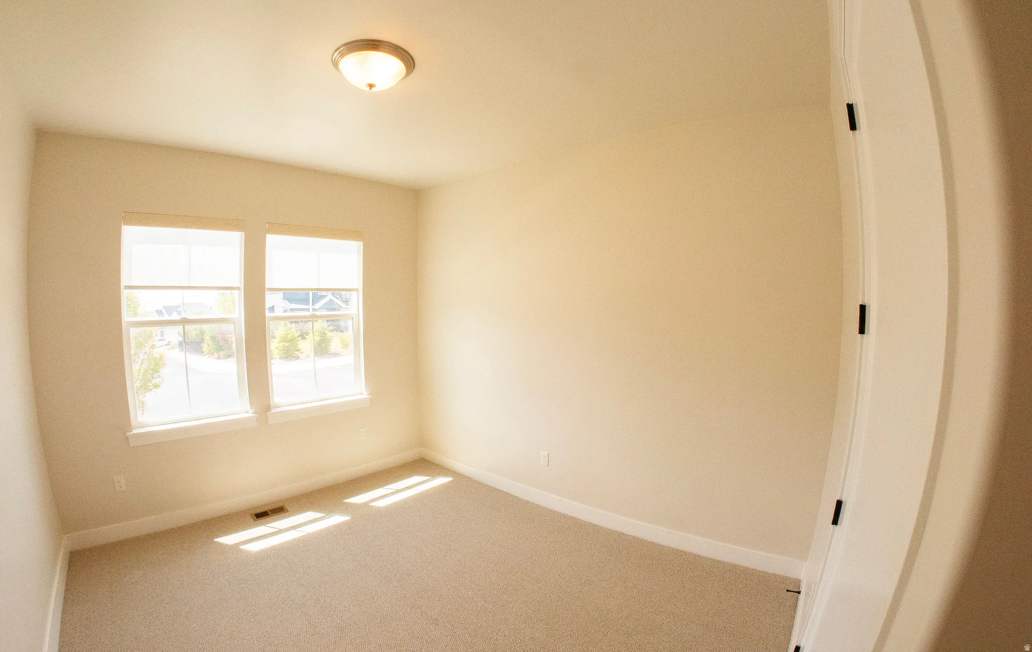 Neutral-toned walls and plush carpeting