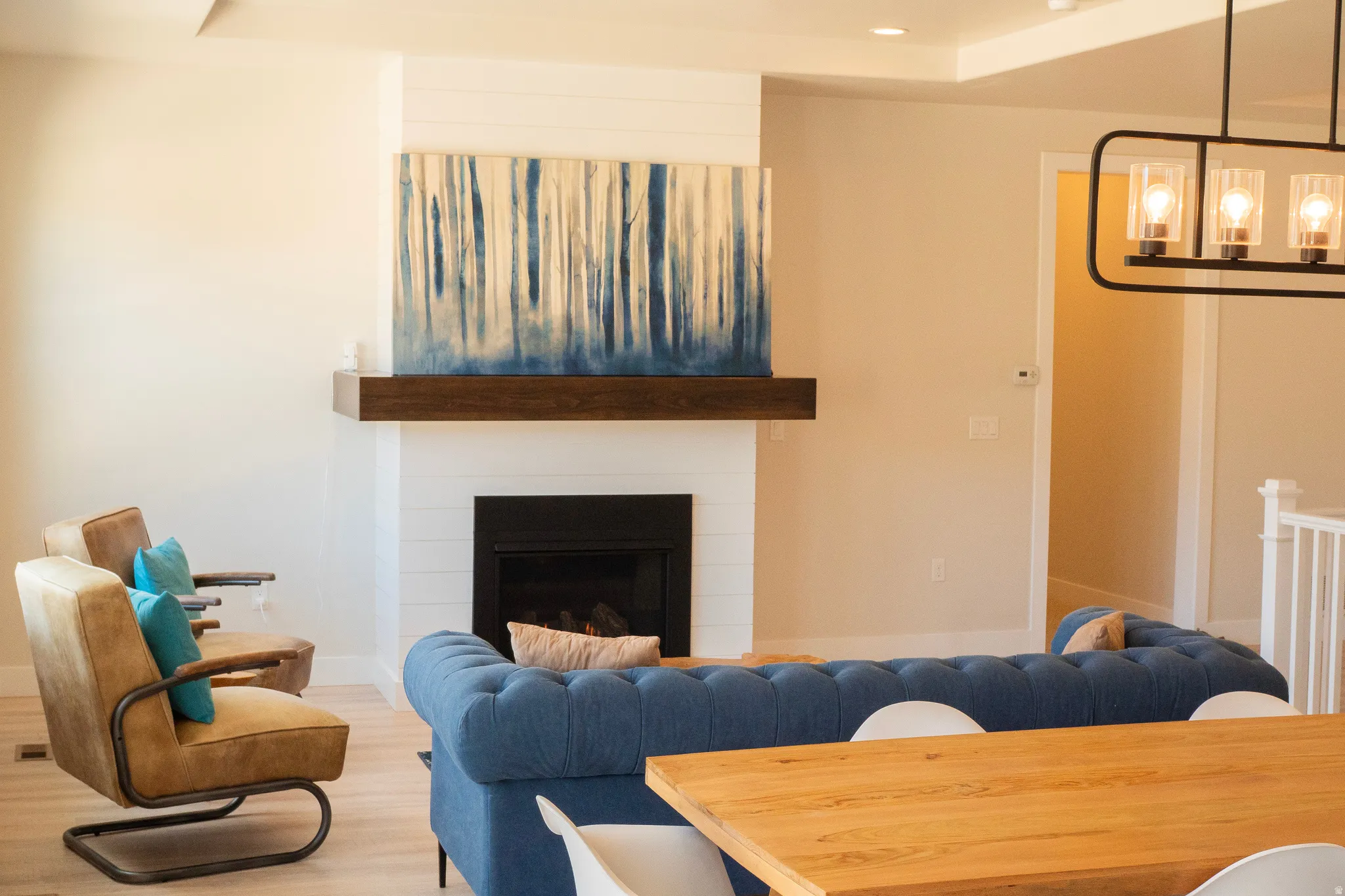 Living area featuring a fireplace with a wood mantle and shiplap surround