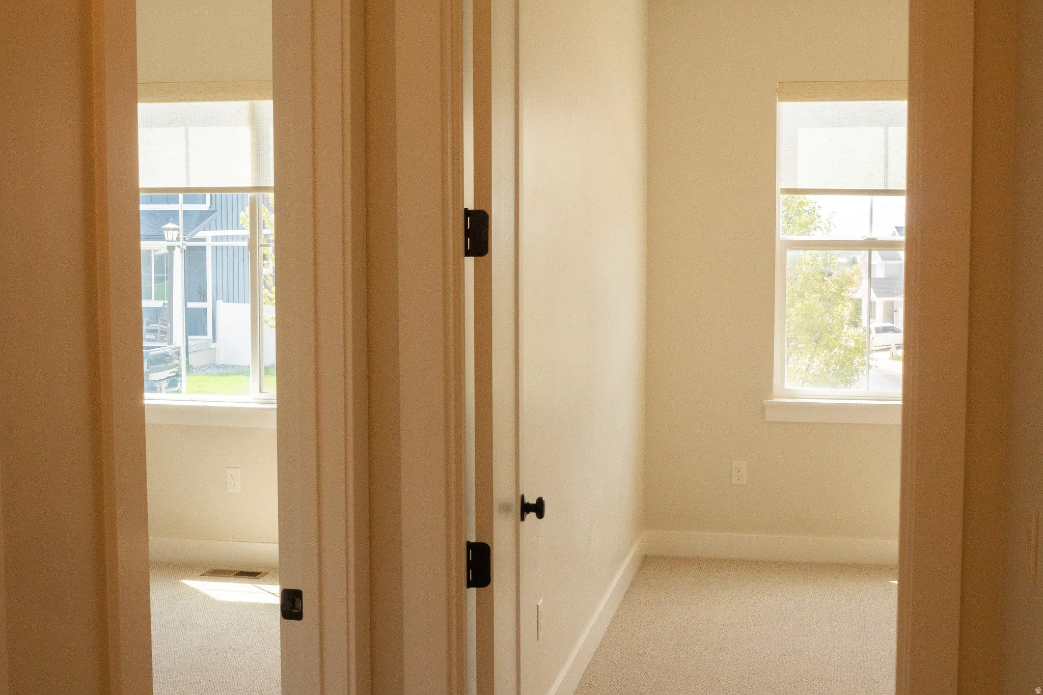 Interior doorway featuring light-colored walls and carpeted flooring