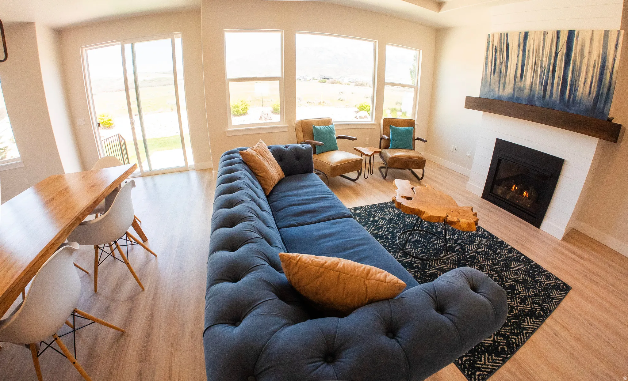 Spacious open-concept living area featuring light wood-finish flooring