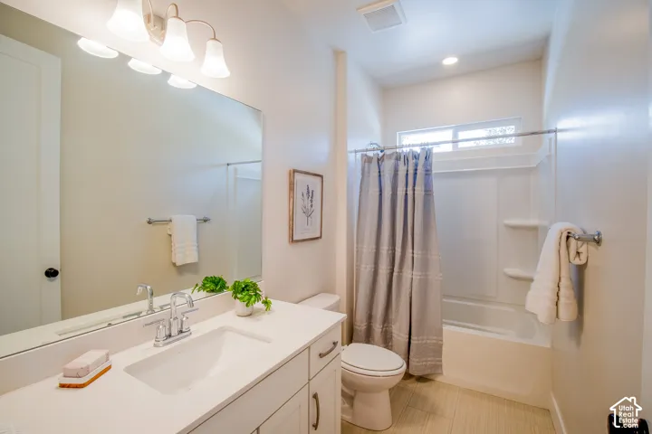 White vanity with an integrated sink, polished chrome faucet, and expansive mirror